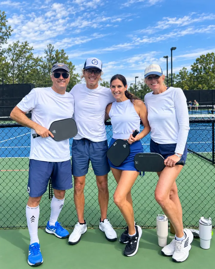 Jen with three players smiling after a session