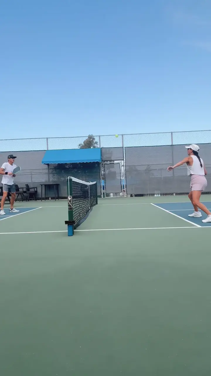 Jen warming up with a volley exchange across the net